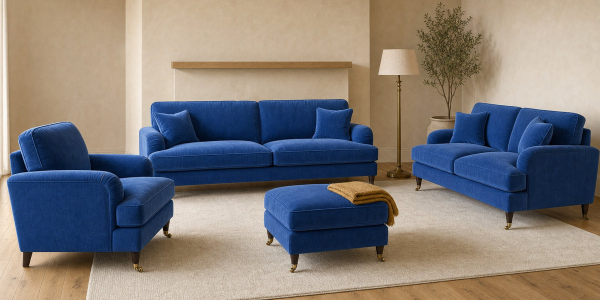 Payton three-seater sofa, two-seater sofa, armchair and footstool in Plush Velvet Blue in a living room